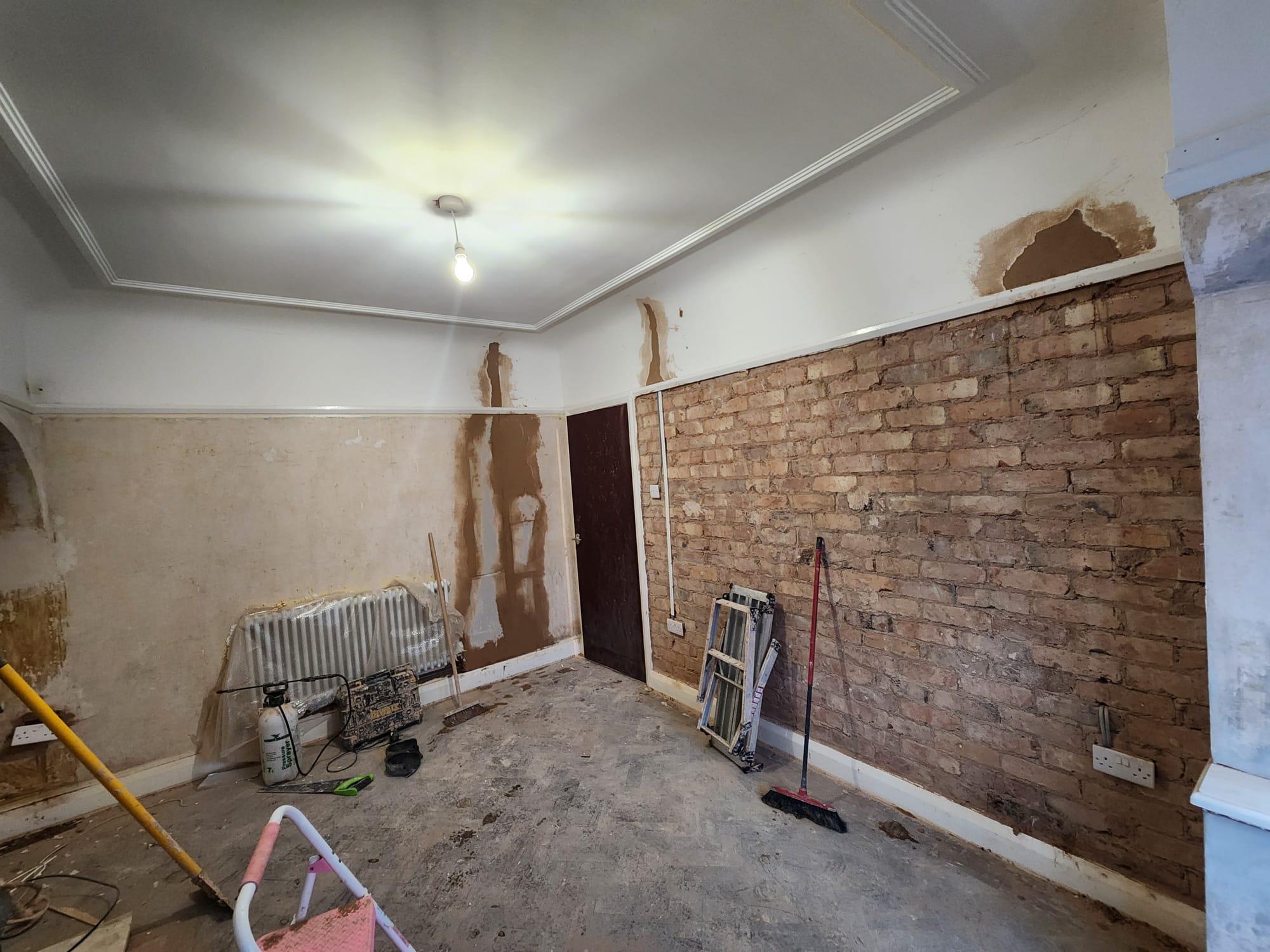 Before plastering photo showing exposed brickwork and patching