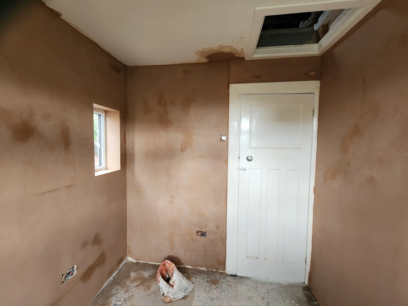 Fresh plastering work inside a bright living room