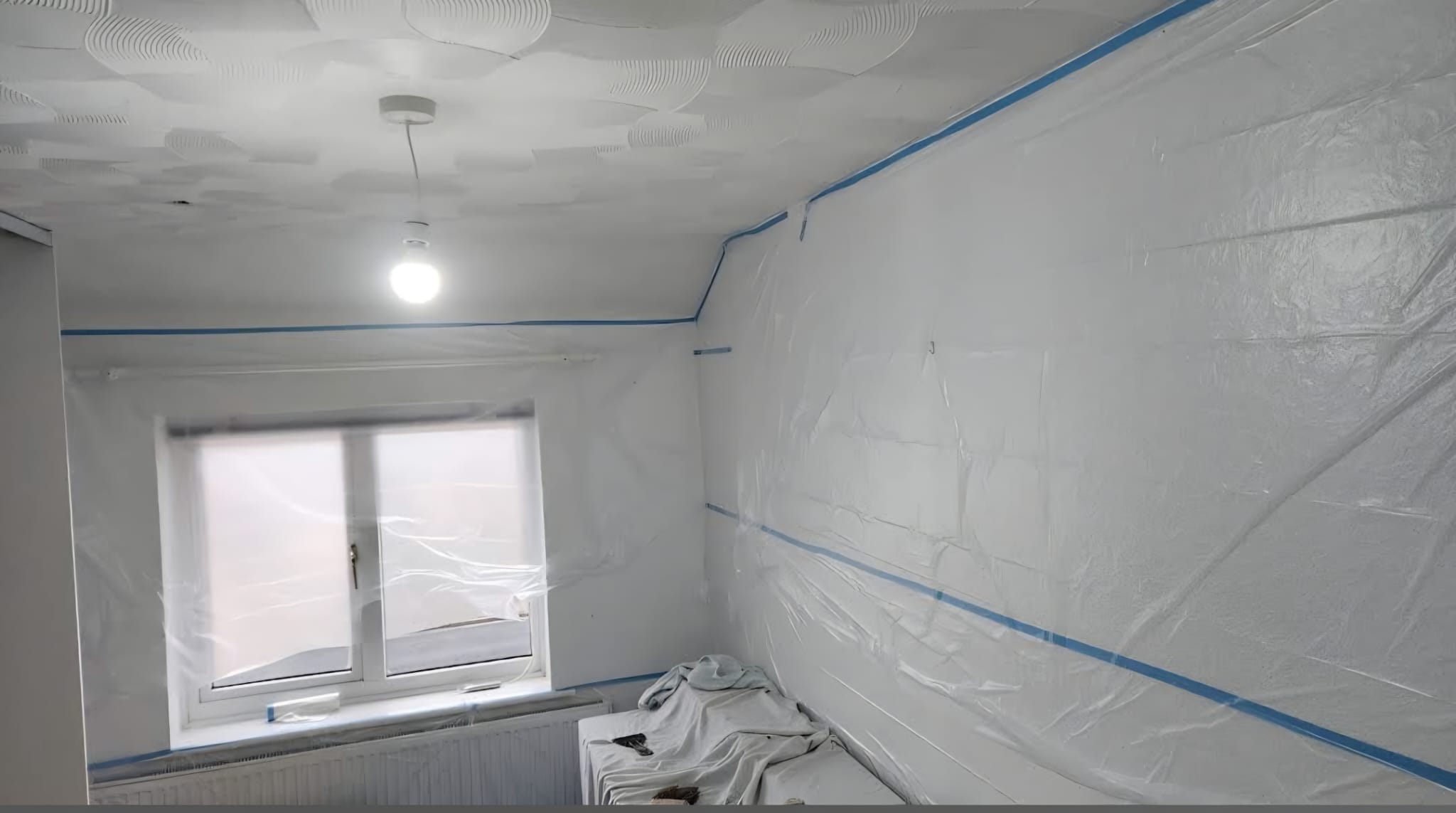 Early preparation stage before specialist skim over artex ceiling work